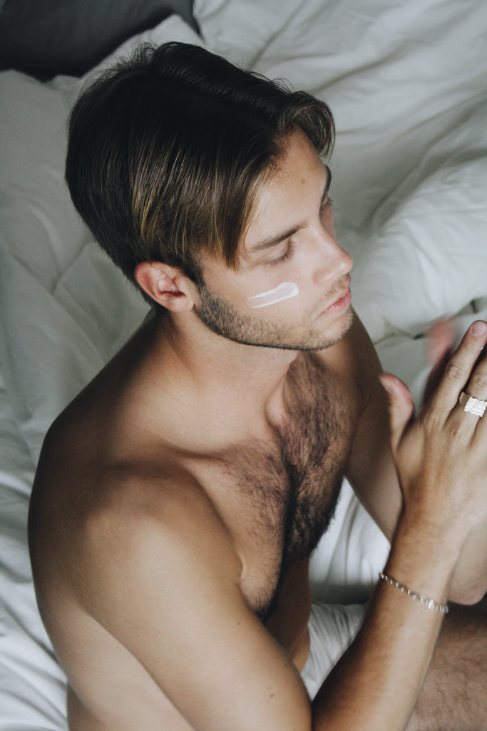 Man applying moisturizing facial cream  to his face. Vegan, nurturing, anti-pollution skincare. Packed with natural antioxidants and powerful agents protecting your skin from air pollution. Crafted in Sweden.
